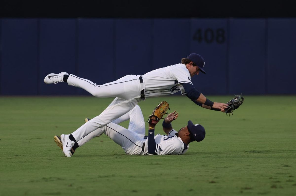 Sep 2, 2025; St. Petersburg, Florida, USA;  Tampa Bay Rays shortstop Carson Williams (77) catches the ball over outfielder Chandler Simpson (14) during the first inning against the Seattle Mariners at George M. Steinbrenner Field. Mandatory Credit: Kim Klement Neitzel-Imagn Images