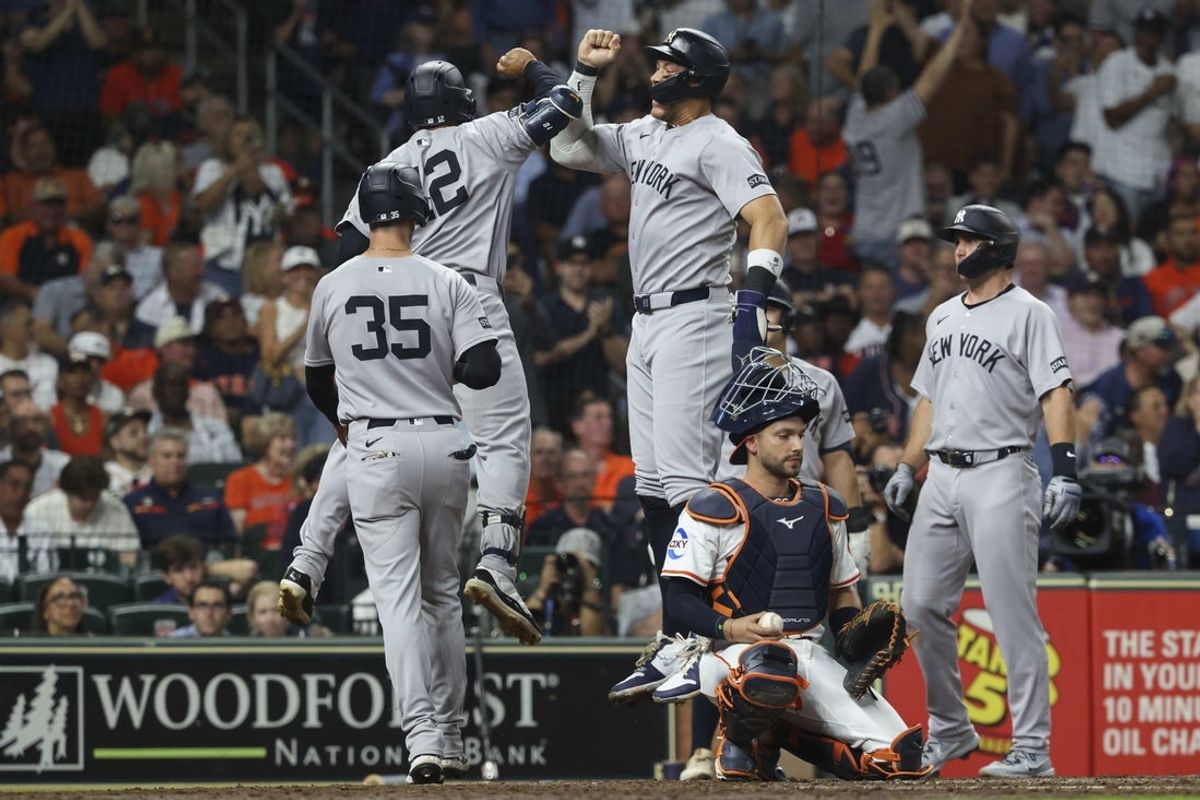 Sep 2, 2025; Houston, Texas, USA; Houston Astros catcher Cesar Salazar (18) looks on as New York Yankees designated hitter Aaron Judge (99) and center fielder Trent Grisham (12) celebrate after Grisham hits a grans slam during the fifth inning at Daikin Park. Mandatory Credit: Troy Taormina-Imagn Images