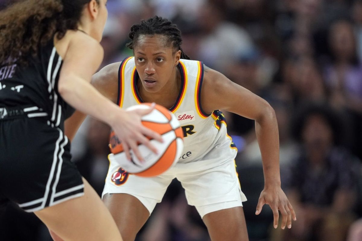 Aug 31, 2025; San Francisco, California, USA; Indiana Fever guard Kelsey Mitchell (center) defends against Golden State Valkyries guard Carla Leite (left) during the third quarter at Chase Center. Mandatory Credit: Darren Yamashita-Imagn Images