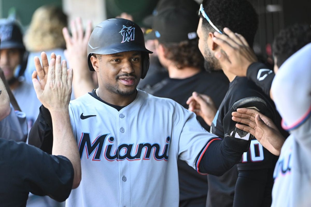Sep 3, 2025; Washington, District of Columbia, USA; Miami Marlins second baseman Xavier Edwards (9) is congratulated by teammates after scoring a run against the Washington Nationals during the fifth inning at Nationals Park. Mandatory Credit: Brad Mills-Imagn Images
