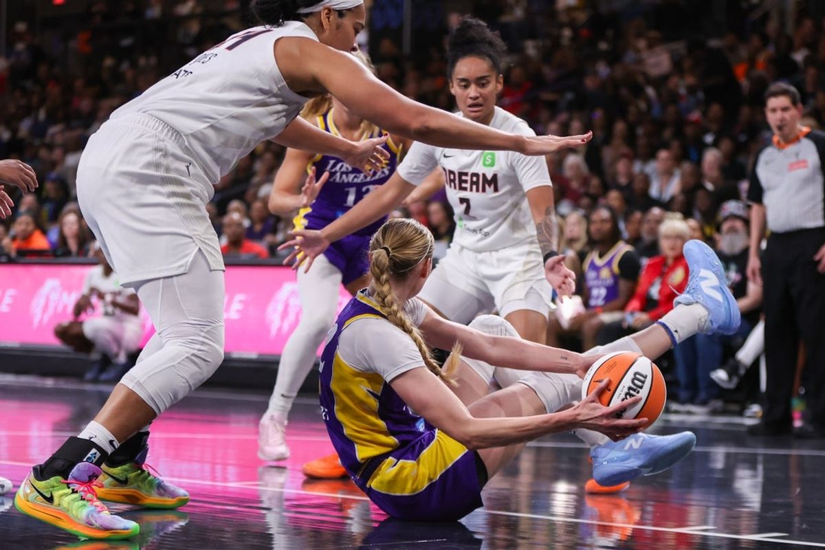 Sep 3, 2025; College Park, Georgia, USA; Los Angeles Sparks forward Cameron Brink (22) grabs a loose ball past Atlanta Dream forward Brionna Jones (24) and guard Te-Hina Paopao (2) in the second quarter at Gateway Center Arena at College Park. Mandatory Credit: Brett Davis-Imagn Images
