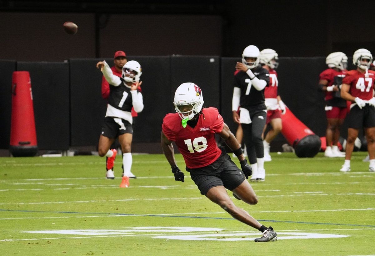 Arizona Cardinals quarterback Kyler Murray (1) throws a pass to wide receiver Marvin Harrison Jr. (18) during training camp at State Farm Stadium in Glendale on July 25, 2025.