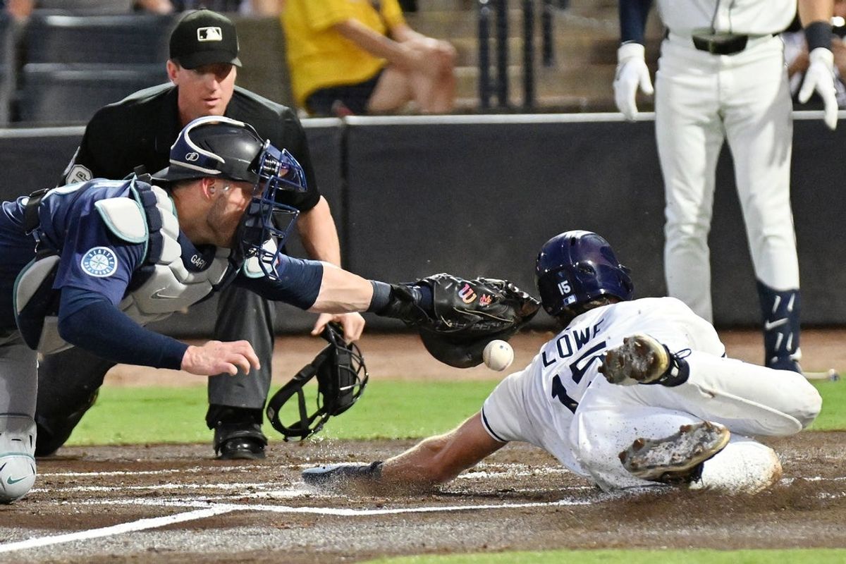 Sep 3, 2025; St. Petersburg, Florida, USA; Tampa Bay Rays right fielder Josh Lowe (15) slides past Seattle Mariners catcher Mitch Garver (18) to score a run in the first inning  at George M. Steinbrenner Field. Mandatory Credit: Jonathan Dyer-Imagn Images