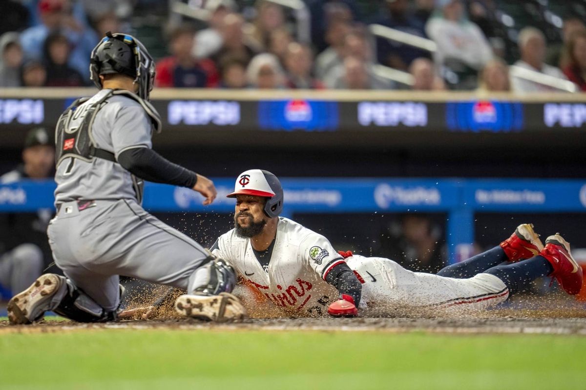 Sep 3, 2025; Minneapolis, Minnesota, USA; Minnesota Twins center fielder Byron Buxton (25) slides into home plate and gets tagged out from Chicago White Sox catcher Edgar Quero (7) in the fifth inning at Target Field. Mandatory Credit: Jesse Johnson-Imagn Images