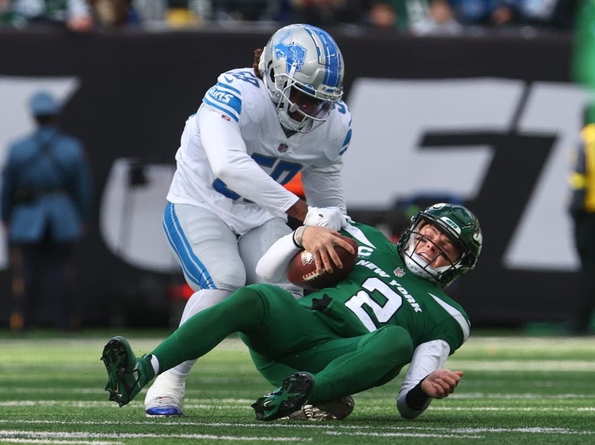 Dec 18, 2022; East Rutherford, New Jersey, USA; New York Jets quarterback Zach Wilson (2) is sacked by Detroit Lions linebacker James Houston (59) during the first half at MetLife Stadium.