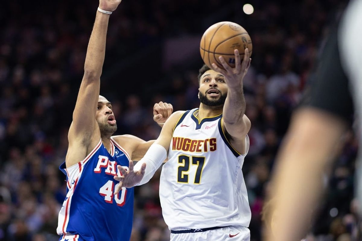 Jan 16, 2024; Philadelphia, Pennsylvania, USA; Denver Nuggets guard Jamal Murray (27) drives for a score past Philadelphia 76ers forward Nicolas Batum (40) during the second quarter at Wells Fargo Center.