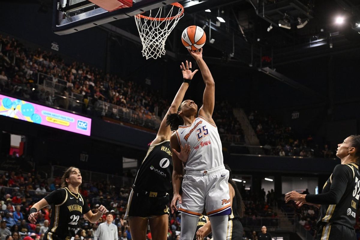 Sep 4, 2025; Washington, District of Columbia, USA;  Phoenix Mercury forward Alyssa Thomas (25) grabs a rebound in front of Washington Mystics forward Shakira Austin (0) during the second quarter at CareFirst Arena. Mandatory Credit: Rafael Suanes-Imagn Images