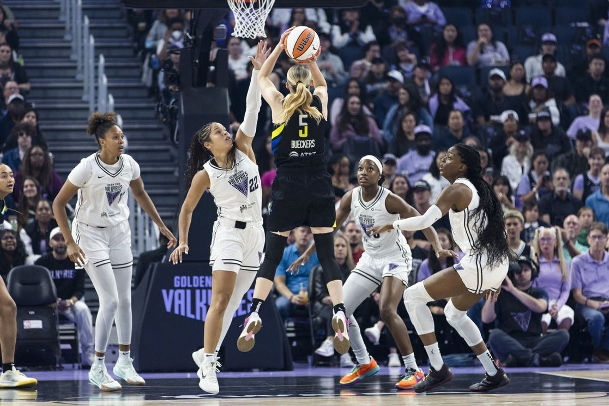 Sep 4, 2025; San Francisco, California, USA;  Dallas Wings guard Paige Bueckers (5) shoots as Golden State Valkyries guard Veronica Burton (22) and other players defend during the first quarter at Chase Center. Mandatory Credit: John Hefti-Imagn Images