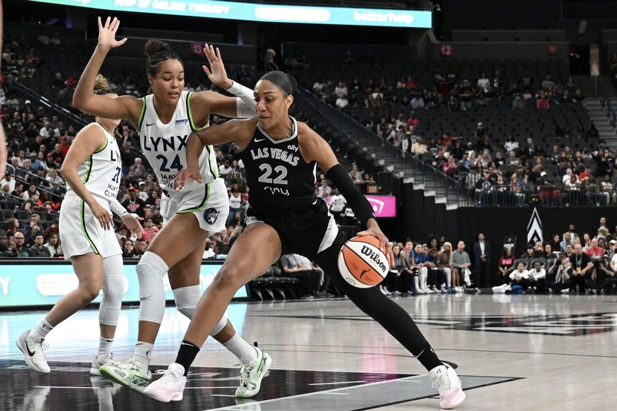 Sep 4, 2025; Las Vegas, Nevada, USA; Las Vegas Aces center A'ja Wilson (22) drives against Minnesota Lynx forward Napheesa Collier (24) in the first quarter of their game at T-Mobile Arena. Mandatory Credit: Candice Ward-Imagn Images