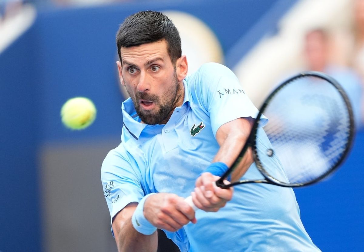 Sep 5, 2025; Flushing, NY, USA;  Novak Djokovic (SRB) hits to Carlos Alcaraz (ESP) (not pictured) on day thirteen of the 2025 U.S. Open tennis tournament at the USTA Billie Jean King National Tennis Center. Mandatory Credit: Robert Deutsch-Imagn Images