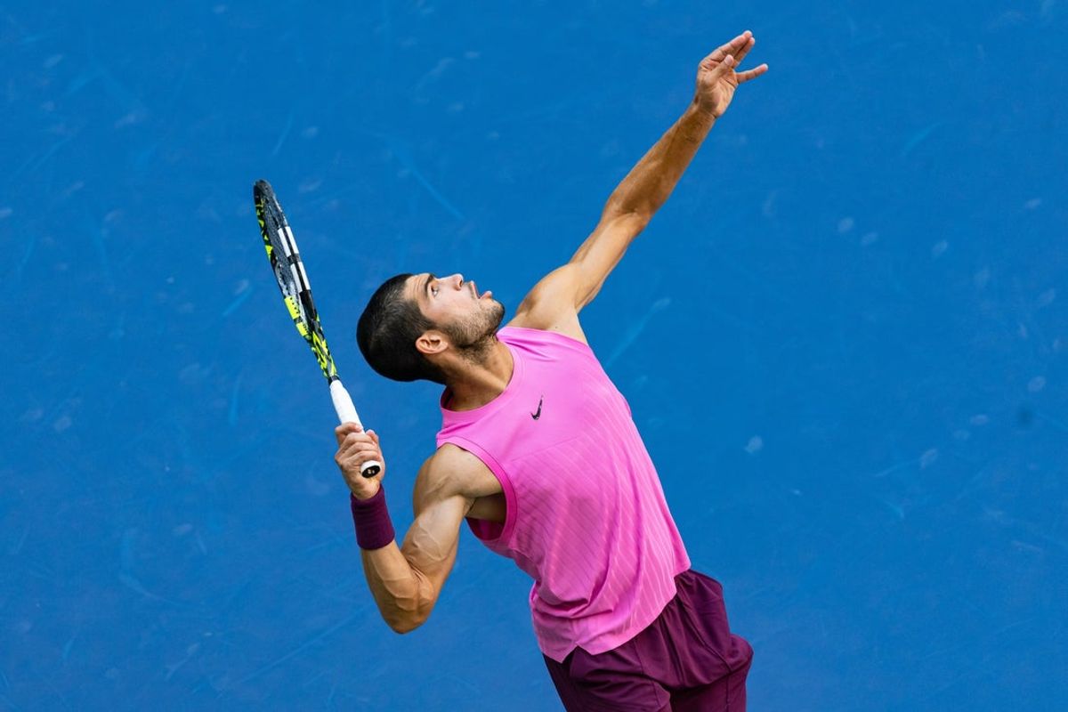 Sep 5, 2025; Flushing, NY, USA; Carlos Alcaraz of Spain serves against Novak Djokovic of Serbia in the semifinal of the menís singles at the US Open at Arthur Ashe Stadium in Billie Jean King National Tennis Center. Mandatory Credit: Mike Frey-Imagn Images