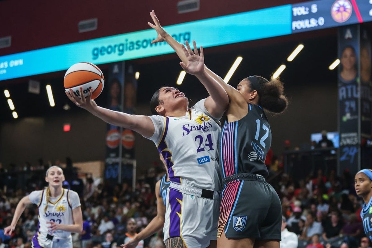 Sep 5, 2025; College Park, Georgia, USA; Los Angeles Sparks forward Alissa Pili (24) shoots the ball against Atlanta Dream forward Nia Coffey (12) during the second quarter at Gateway Center Arena at College Park. Mandatory Credit: Jordan Godfree-Imagn Images