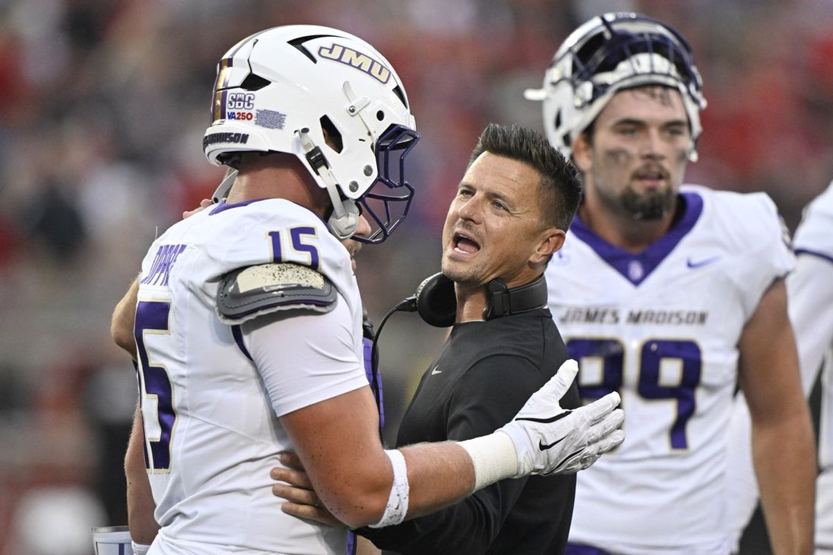 Sep 5, 2025; Louisville, Kentucky, USA;  James Madison Dukes head coach Bob Chesney talks with tight end Lacota Dippre (15) during the first quarter against the Louisville Cardinals at L&N Federal Credit Union Stadium. Mandatory Credit: Jamie Rhodes-Imagn Images