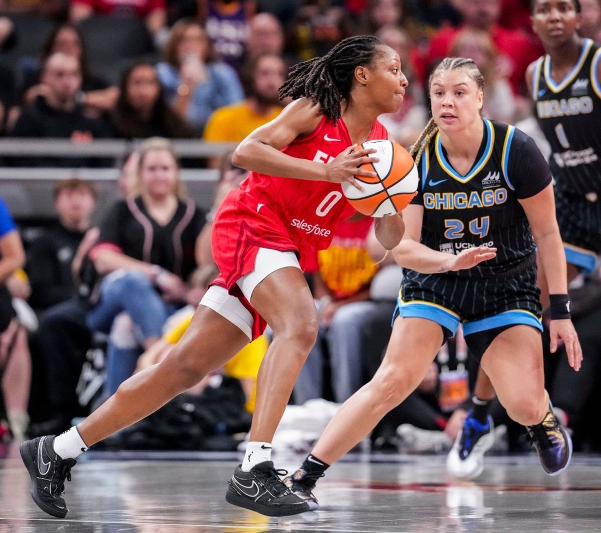 Indiana Fever guard Kelsey Mitchell (0) runs a play against Chicago Sky guard Rachel Banham (24) on Friday, Sept. 5, 2025, during a game between the Indiana Fever and the Chicago Sky at Gainbridge Fieldhouse in Indianapolis.