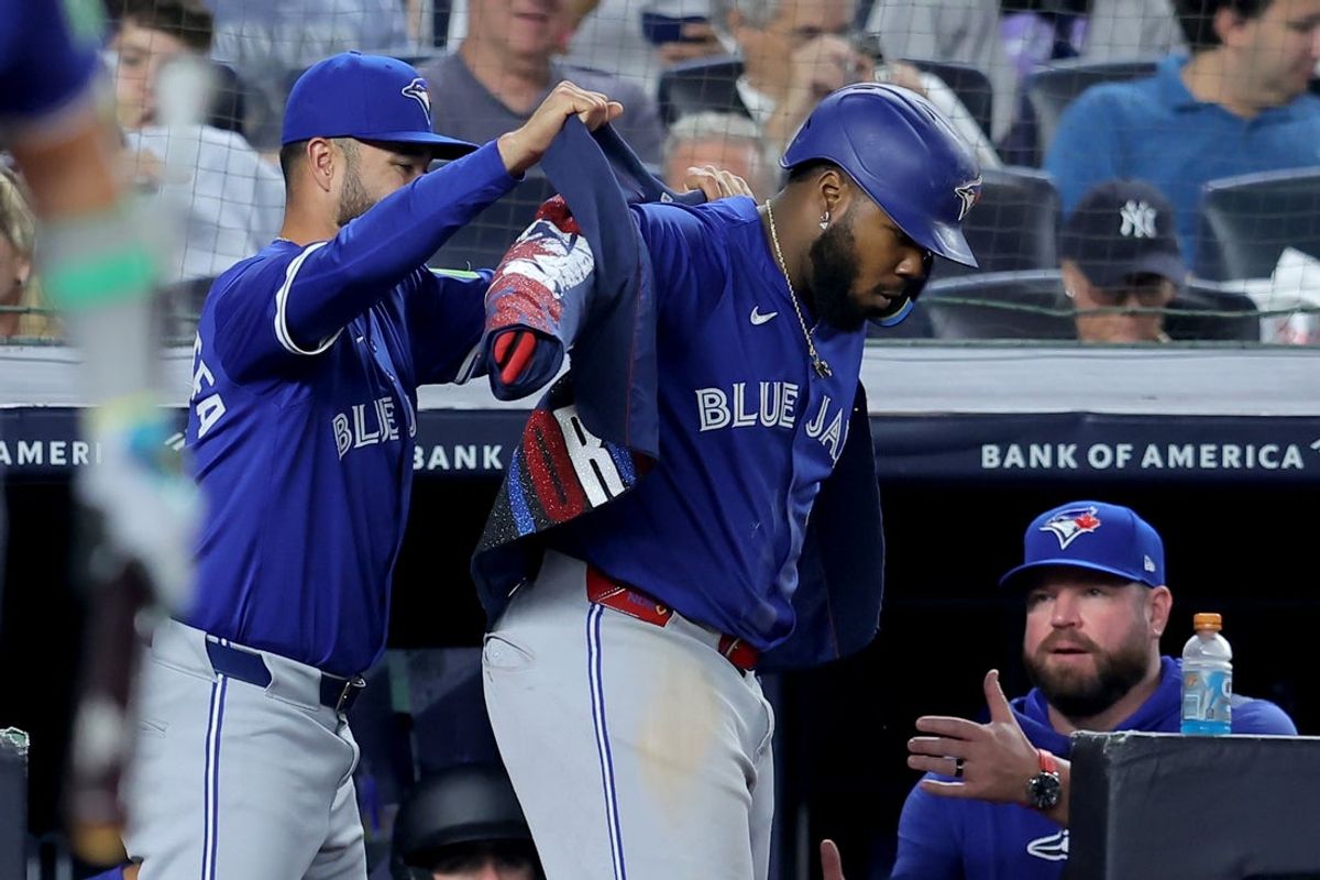 Sep 5, 2025; Bronx, New York, USA; Toronto Blue Jays shortstop Isiah Kiner-Falefa (7) puts the home run jacket on first baseman Vladimir Guerrero Jr. (27) after Guerrero hit a solo home run the New York Yankees during the fifth inning at Yankee Stadium. Mandatory Credit: Brad Penner-Imagn Images
