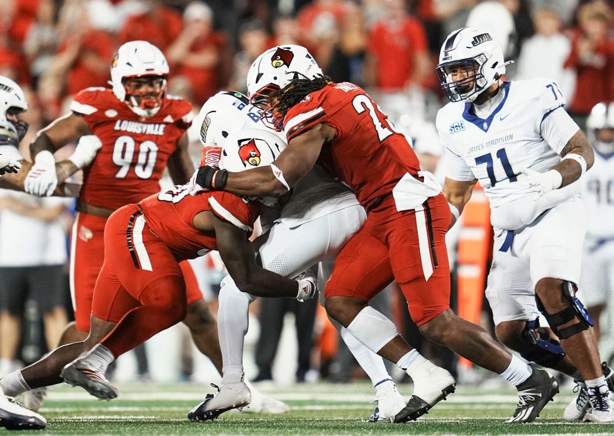 Louisville Cardinals defensive lineman Clev Lubin (50) and Louisville Cardinals defensive lineman Wesley Bailey (23) sack DUPLICATE***James Madison Dukes quarterback Alonza Barnett III (14) in the first half during the Louisville-James Madison college football game Friday September 5, 2025 at L&N Credit Union Stadium in Louisville, Kentucky. They used to bring into games under the Schnellenberger era.