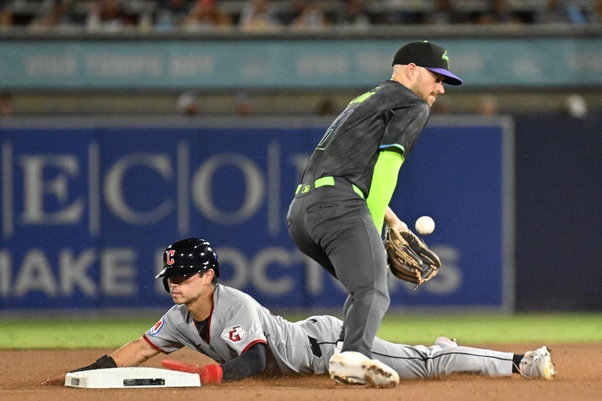 Sep 5, 2025; St. Petersburg, Florida, USA; Cleveland Guardians left fielder Steven Kwan (38) slides into second base as Tampa Bay Rays second baseman Brandon Lowe (8) catches the ball in the fourth inning at George M. Steinbrenner Field. Mandatory Credit: Jonathan Dyer-Imagn Images