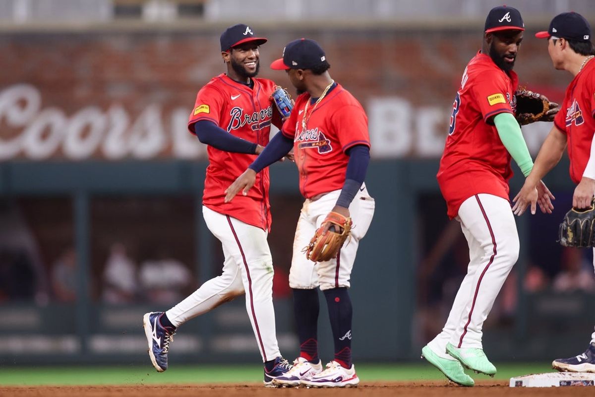 Sep 5, 2025; Atlanta, Georgia, USA; Atlanta Braves left fielder Jurickson Profar (7) and second baseman Ozzie Albies (1) celebrate after a victory over the Seattle Mariners at Truist Park. Mandatory Credit: Brett Davis-Imagn Images