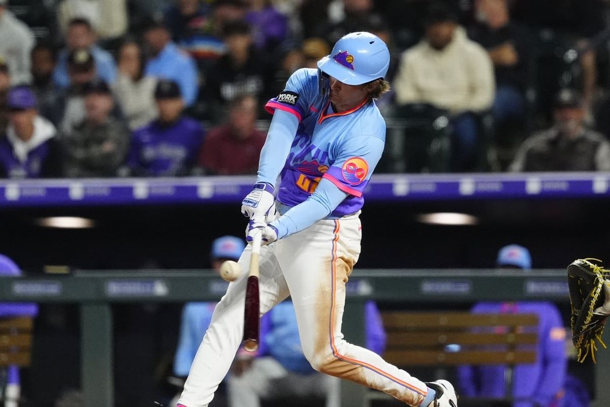 Sep 5, 2025; Denver, Colorado, USA; Colorado Rockies right fielder Mickey Moniak (22) singles in the fifth inning against the San Diego Padres at Coors Field. Mandatory Credit: Ron Chenoy-Imagn Images