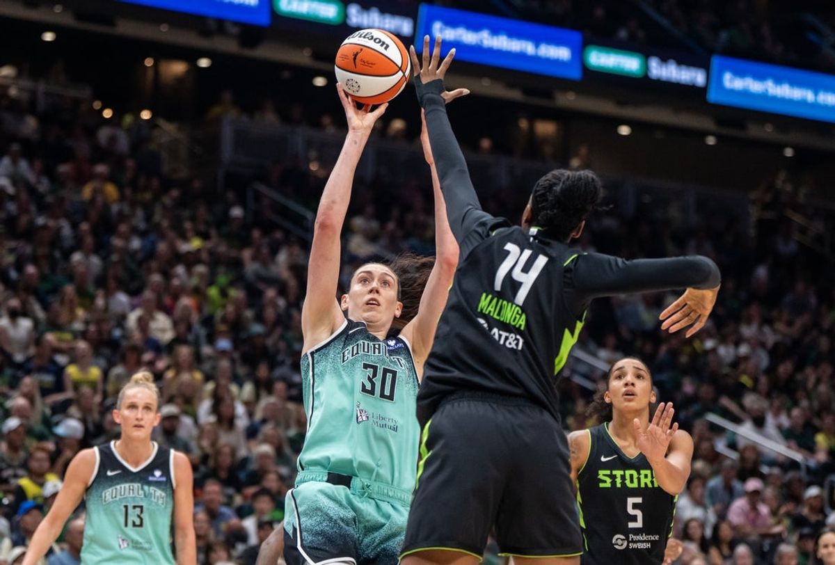 Sep 5, 2025; Seattle, Washington, USA;  New York Liberty forward Breanna Stewart (30) shoots the ball against Seattle Storm center Dominique Malonga (14) during the first half at Climate Pledge Arena. Mandatory Credit: Stephen Brashear-Imagn Images