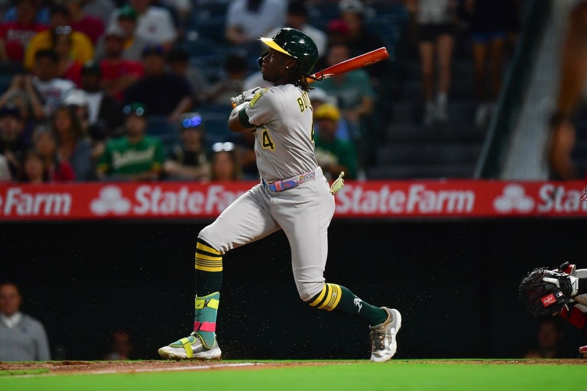 Sep 5, 2025; Anaheim, California, USA; Athletics center fielder Lawrence Butler (4) hits an RBI single against the Los Angeles Angels during the third inning at Angel Stadium. Mandatory Credit: Gary A. Vasquez-Imagn Images