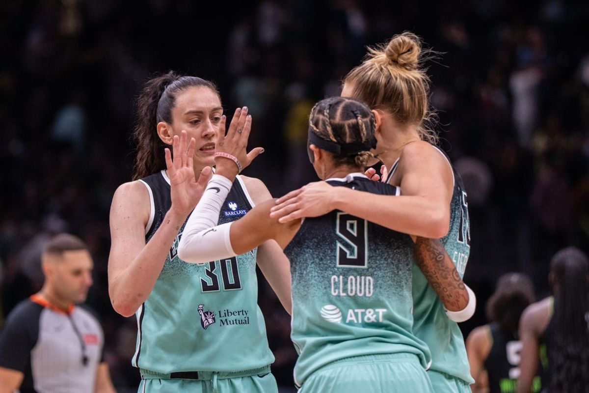 Sep 5, 2025; Seattle, Washington, USA;  New York Liberty forward Breanna Stewart (30) guard Natasha Cloud (9) and forward Leonie Fiebich (13) celebrate after a game against the Seattle Storm at Climate Pledge Arena. Mandatory Credit: Stephen Brashear-Imagn Images