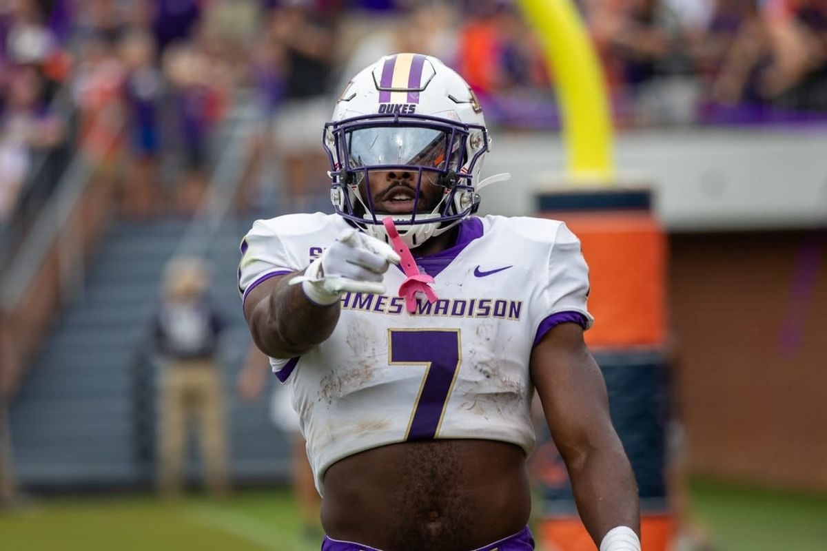Sept 9, 2023; Charlottesville, Virginia, USA; James Madison Dukes running back Ty Son Lawton (7) points at the camera after scoring a touchdown against the Virginia Cavaliers during the second half at Scott Stadium.