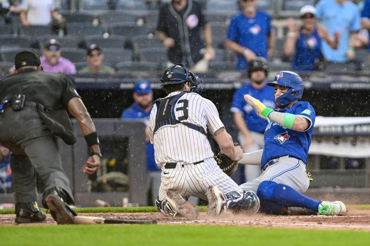 Sep 6, 2025; Bronx, New York, USA; New York Yankees catcher Austin Wells (28) tags out Toronto Blue Jays shortstop Bo Bichette (11) at home plate during the sixth inning at Yankee Stadium. Mandatory Credit: John Jones-Imagn Images