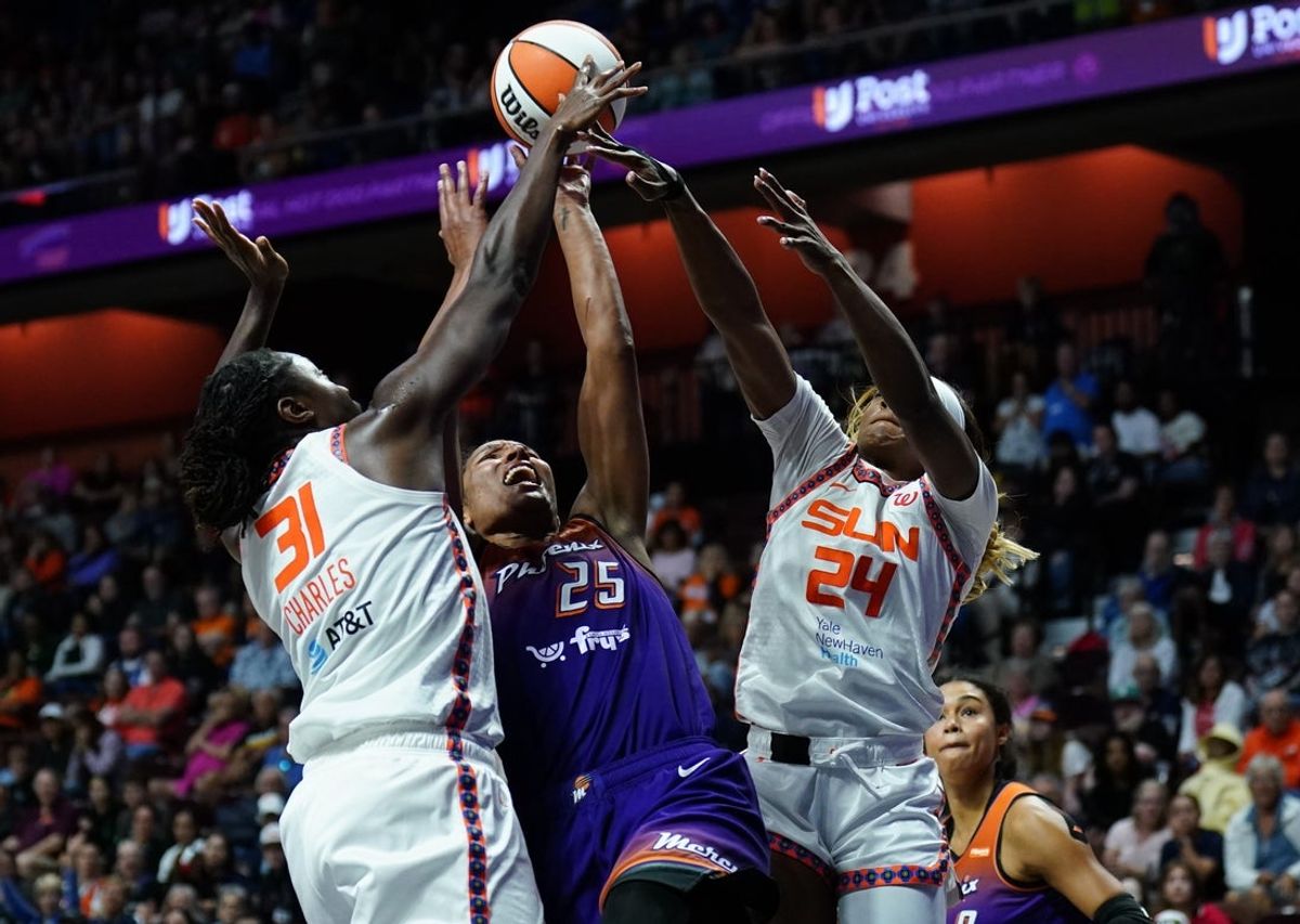 Sep 6, 2025; Uncasville, Connecticut, USA; Connecticut Sun center Tina Charles (31) and forward Aneesah Morrow (24) defend against Phoenix Mercury forward Alyssa Thomas (25) in the second half at Mohegan Sun Arena. Mandatory Credit: David Butler II-Imagn Images