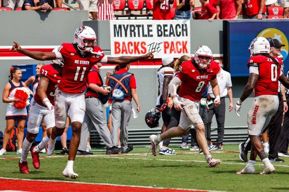 Sep 6, 2025; Raleigh, North Carolina, USA; North Carolina State Wolfpack wide receiver Keenan Jackson (8) celebrates an interception with North Carolina State Wolfpack quarterback CJ Bailey (11) to win the game during the second half of the game against Virginia Cavaliers at Carter-Finley Stadium. Mandatory Credit: Jaylynn Nash-Imagn Images