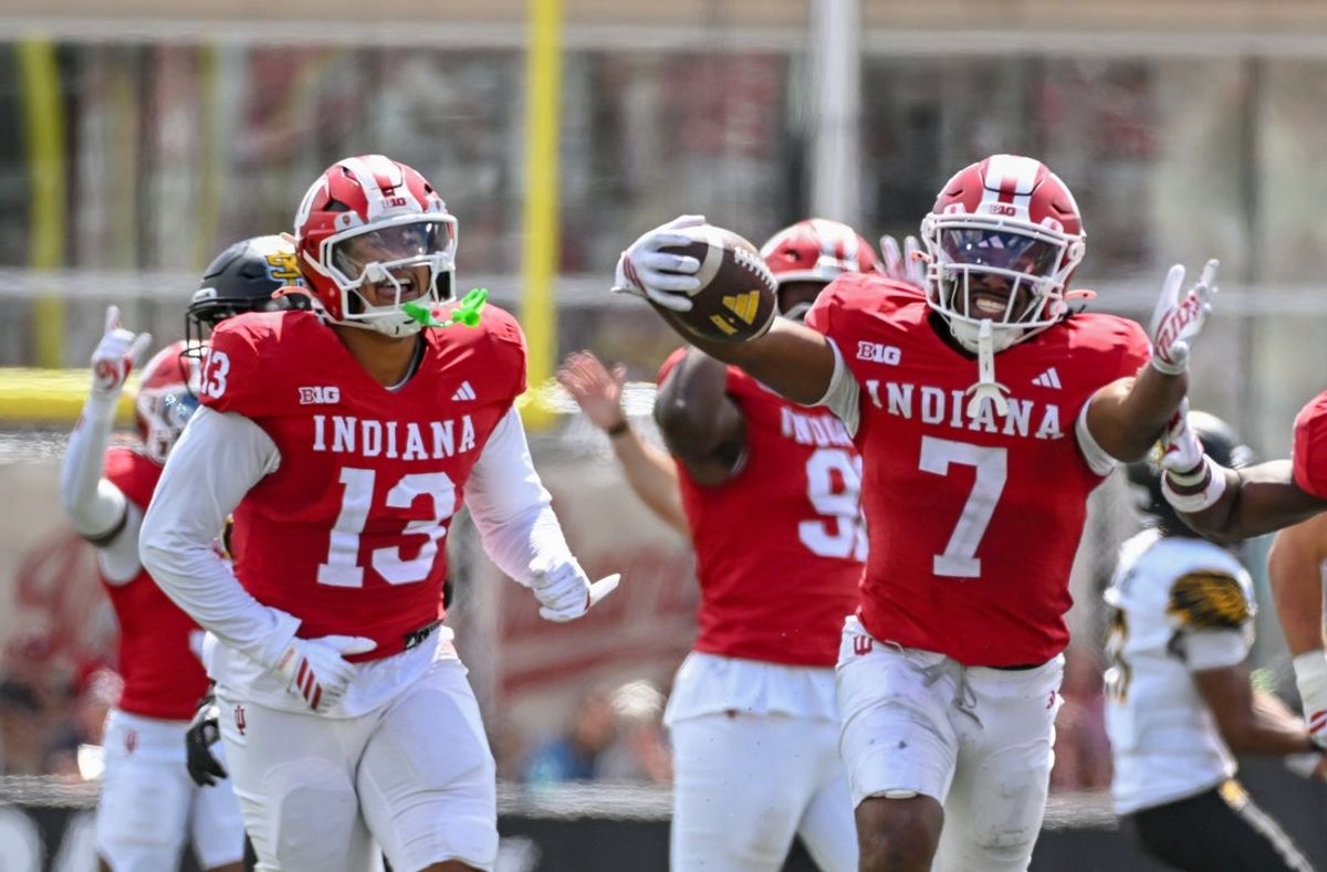 Sep 6, 2025; Bloomington, Indiana, USA; Indiana Hoosiers defensive lineman Kellan Wyatt (13) and defensive back Louis Moore (7) celebrate after forcing a turnover during the second half against the Kennesaw State Owls at Memorial Stadium. Mandatory Credit: Robert Goddin-Imagn Images