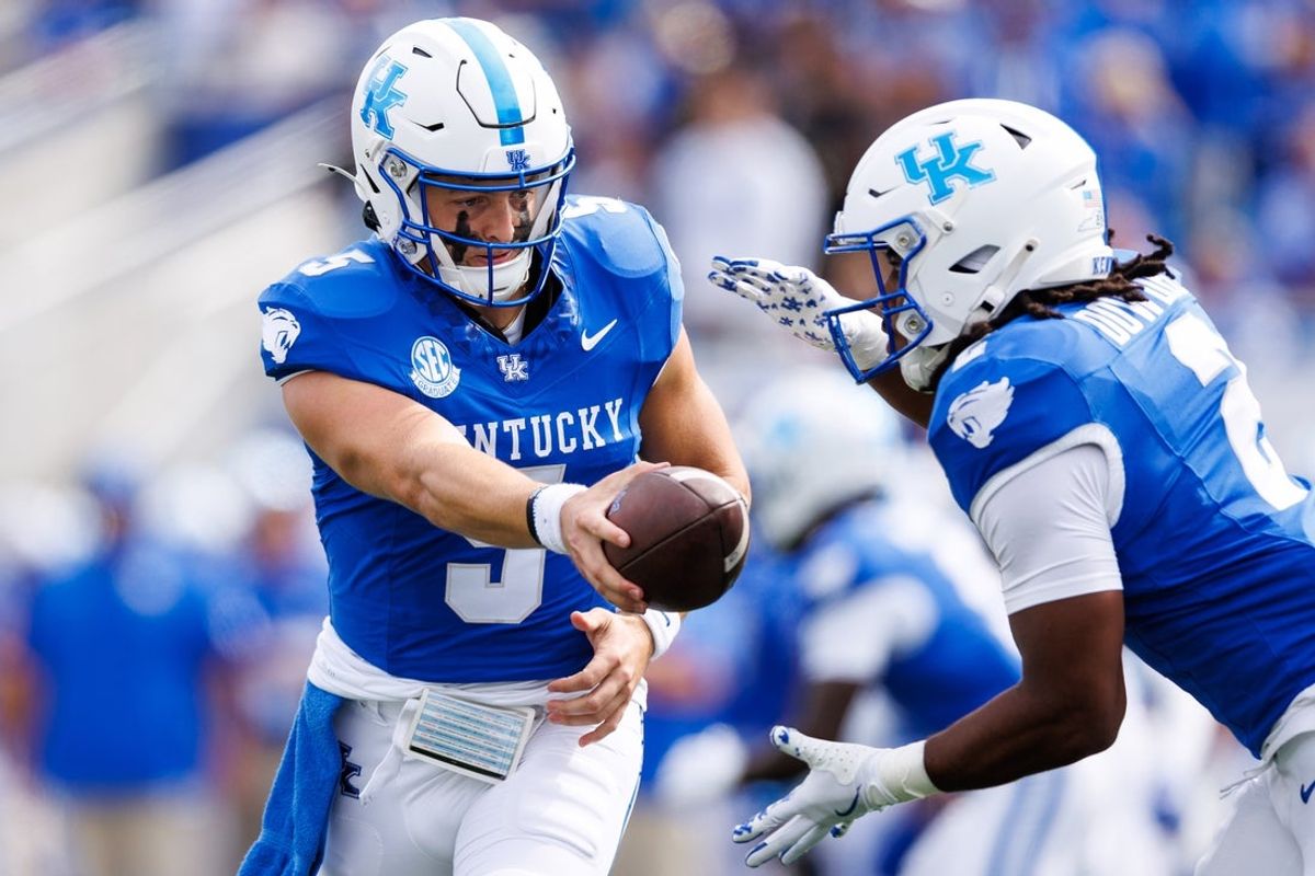Sep 6, 2025; Lexington, Kentucky, USA; Kentucky Wildcats quarterback Zach Calzada (5) hands the ball off to running back Dante Dowdell (2) during the first quarter against the Mississippi Rebels at Kroger Field. Mandatory Credit: Jordan Prather-Imagn Images