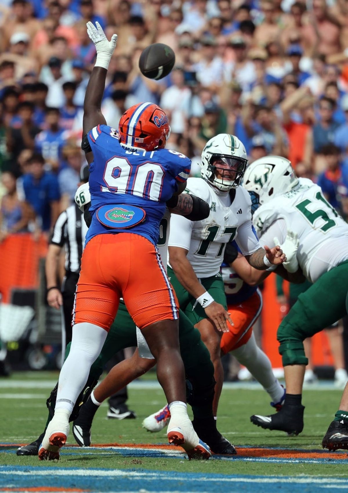 Sep 6, 2025; Gainesville, Florida, USA; South Florida Bulls quarterback Byrum Brown (17) throws the ball over Florida Gators defensive lineman Brendan Bett (90) during the first quarter at Ben Hill Griffin Stadium. Mandatory Credit: Kim Klement Neitzel-Imagn Images