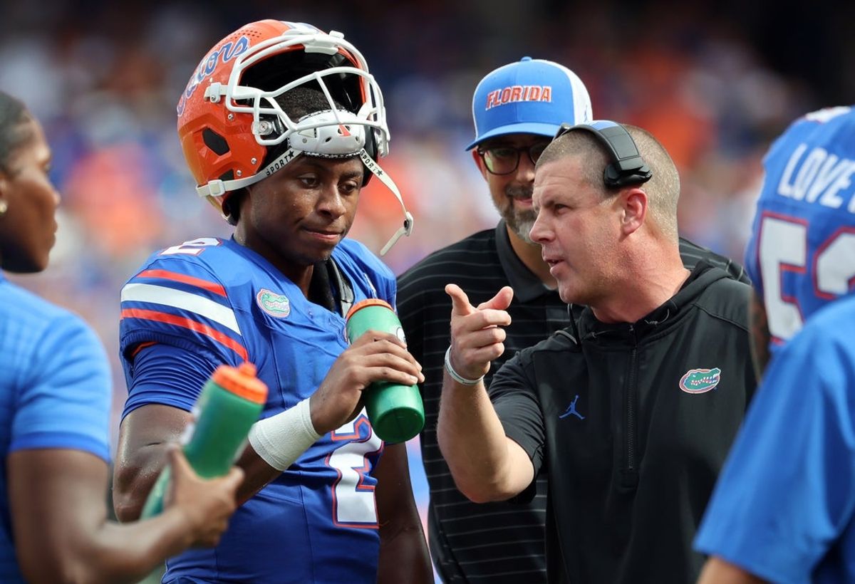 Sep 6, 2025; Gainesville, Florida, USA; Florida Gators head coach Billy Napier talks with Florida Gators quarterback DJ Lagway (2) against the South Florida Bulls during the first quarter at Ben Hill Griffin Stadium. Mandatory Credit: Kim Klement Neitzel-Imagn Images