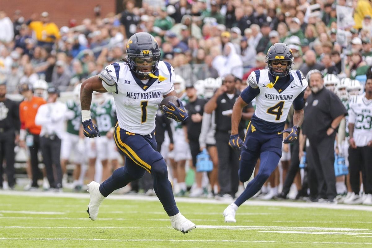 Sep 6, 2025; Athens, Ohio, USA; West Virginia Mountaineers running back Jahiem White (1) runs the ball for a touchdown during the first quarter against the Ohio Bobcats at Peden Stadium. Mandatory Credit: Ben Queen-Imagn Images
