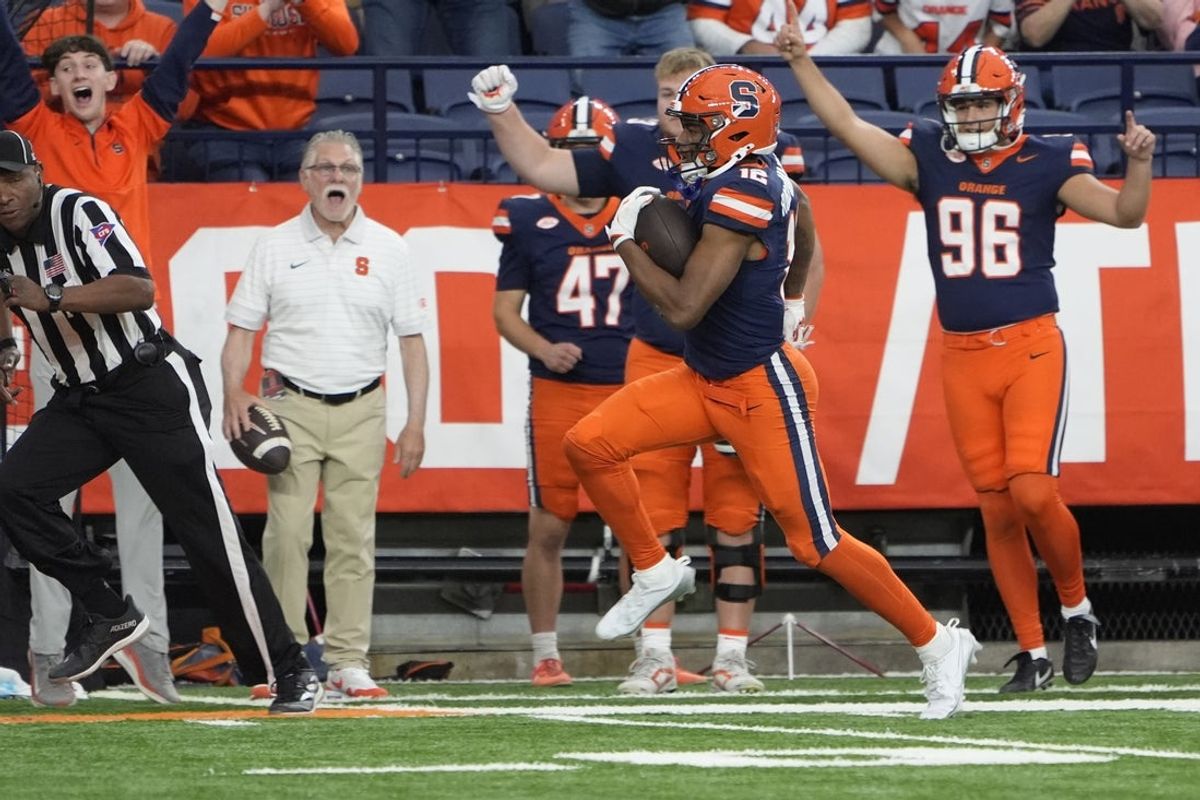Sep 6, 2025; Syracuse, New York, USA; Syracuse Orange wide receiver Justus Ross-Simmons (12) runs after a catch and scores a touchdown against the UConn Huskies during the second half at JMA Wireless Dome. Mandatory Credit: Gregory Fisher-Imagn Images