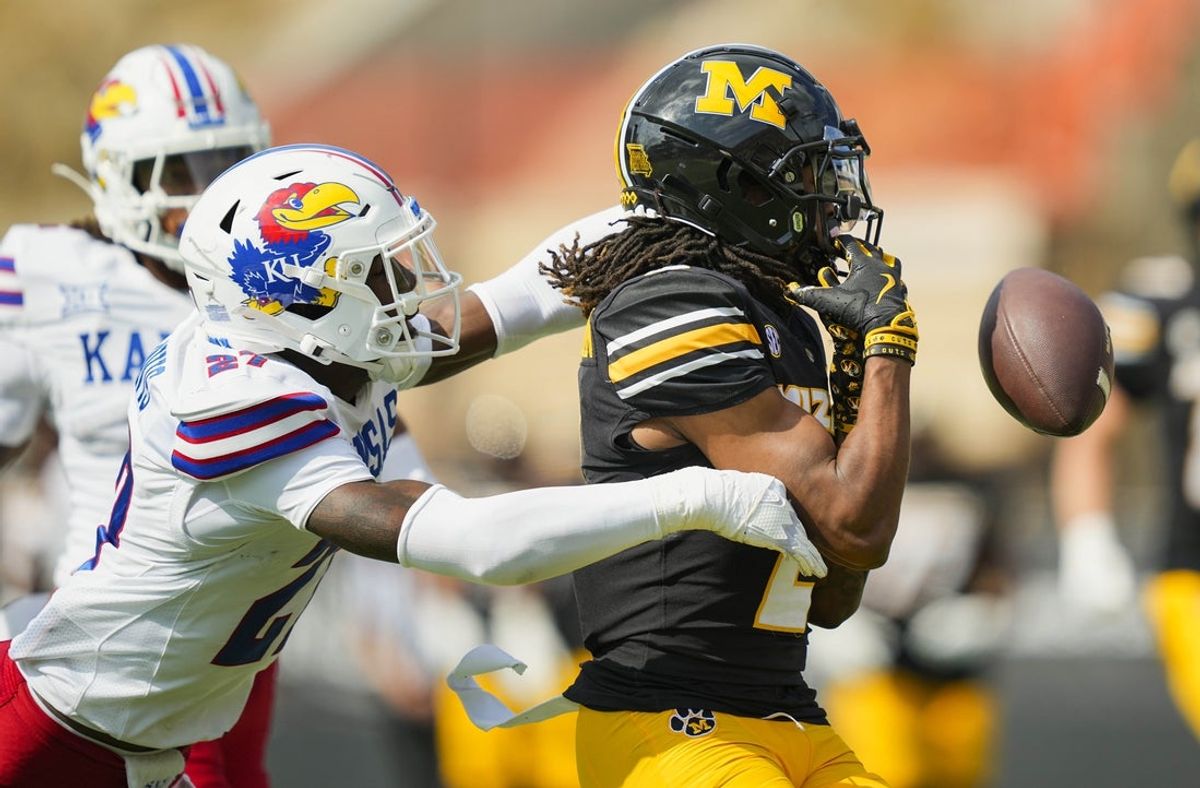 Sep 6, 2025; Columbia, Missouri, USA; Missouri Tigers wide receiver Marquis Johnson (2) is unable to make a catch against Kansas Jayhawks safety Taylor Davis (27) during the first half at Faurot Field at Memorial Stadium. Mandatory Credit: Jay Biggerstaff-Imagn Images