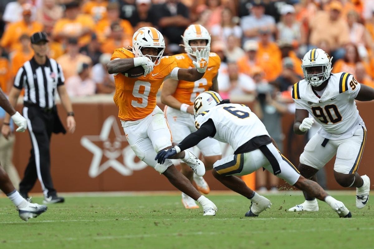 Sep 6, 2025; Knoxville, Tennessee, USA; Tennessee Volunteers running back Star Thomas (9) runs with the ball against East Tennessee State Buccaneers defensive back Jivon Oggs (6) during the second quarter at Neyland Stadium. Mandatory Credit: Randy Sartin-Imagn Images