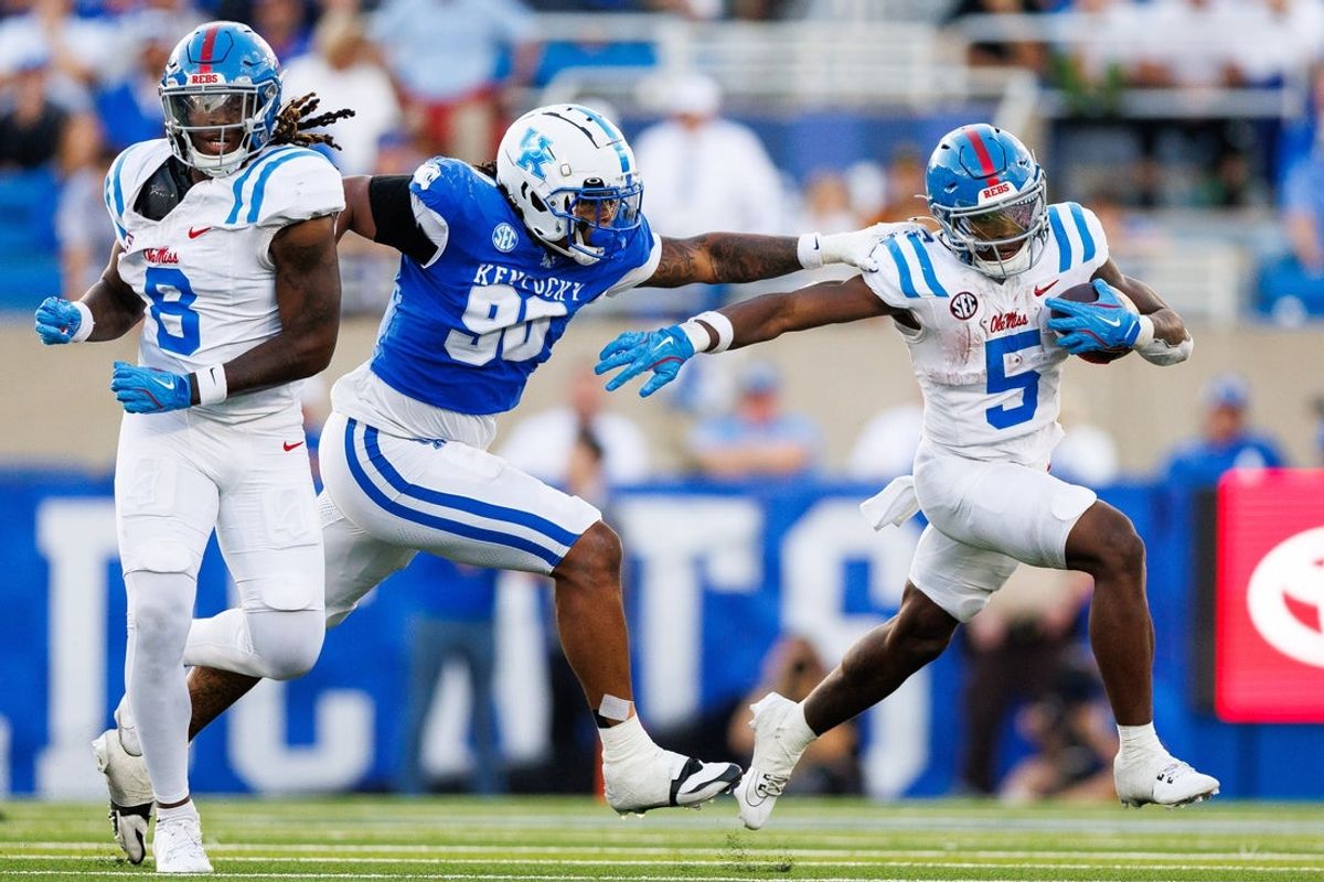 Sep 6, 2025; Lexington, Kentucky, USA; Kentucky Wildcats defensive lineman Mi'Quise Humphrey-Grace (90) reaches for Mississippi Rebels running back Kewan Lacy (5) while tight end Dae'Quan Wright (8) attempts to block during the fourth quarter at Kroger Field. Mandatory Credit: Jordan Prather-Imagn Images