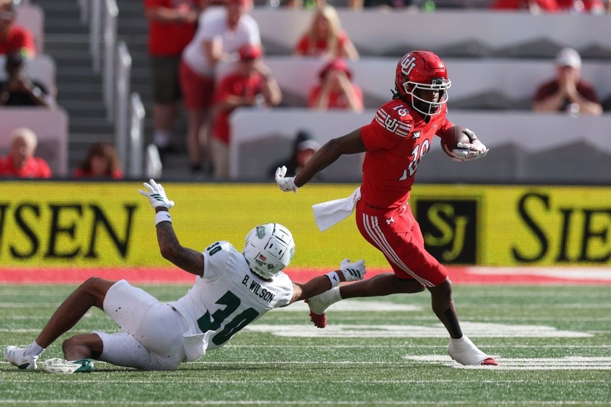 Sep 6, 2025; Salt Lake City, Utah, USA; Utah Utes wide receiver Tobias Merriweather (18) runs after a catch against Cal Poly Mustangs cornerback Boston Wilson (30) during the second quarter at Rice-Eccles Stadium. Mandatory Credit: Rob Gray-Imagn Images