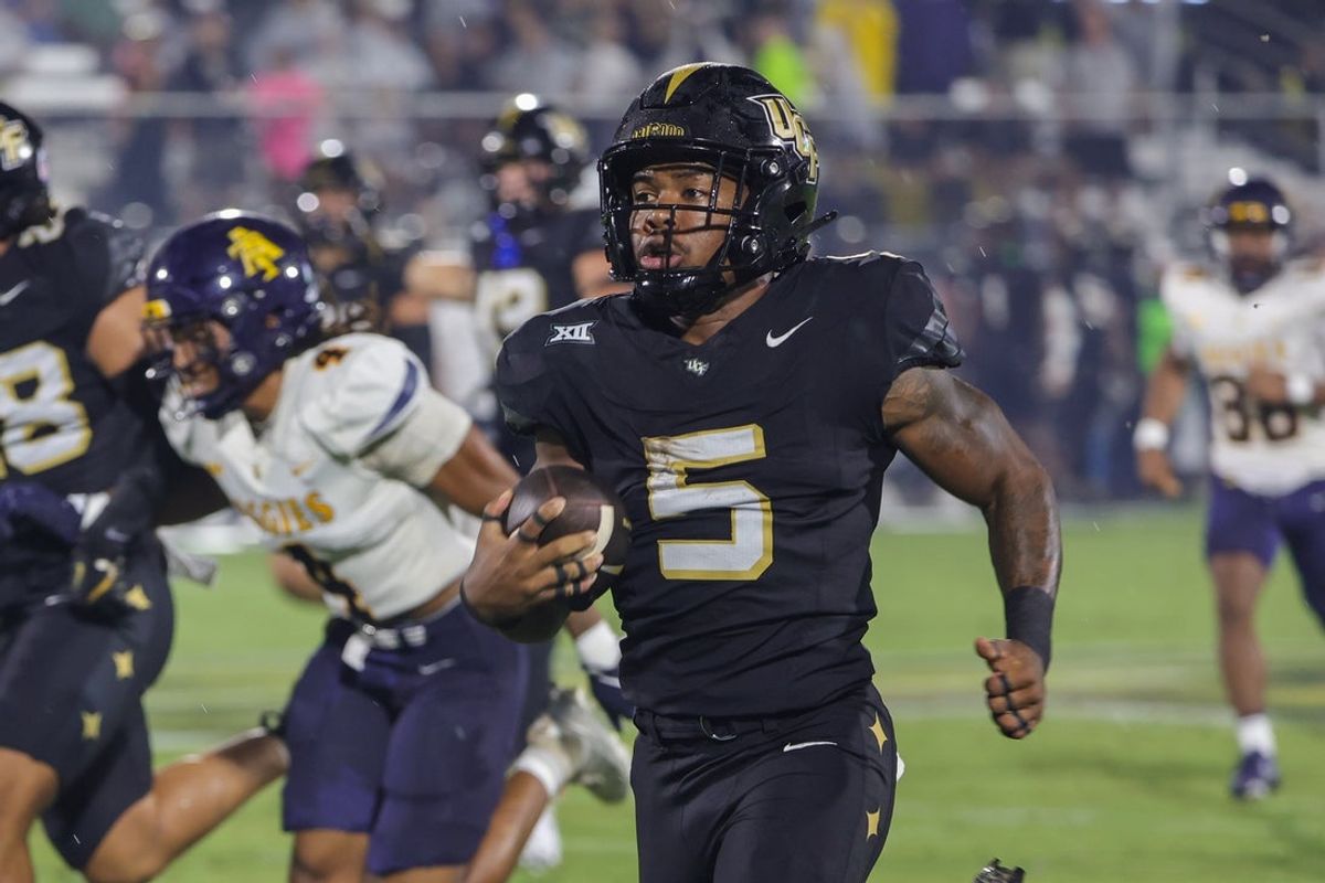 Sep 6, 2025; Orlando, Florida, USA; UCF Knights running back Jaden Nixon (5) runs a 96 yard kickoff return for a touchdown during the first quarter against the North Carolina A&T Aggies at Acrisure Bounce House. Mandatory Credit: Mike Watters-Imagn Images