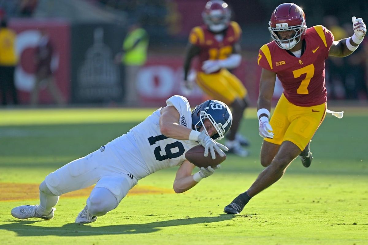 Sep 6, 2025; Los Angeles, California, USA;  Georgia Southern Eagles wide receiver Josh Dallas (19) hangs on to the ball in front of USC Trojans safety Kamari Ramsey (7) for a first down during the first half at the Los Angeles Memorial Coliseum. Mandatory Credit: Jayne Kamin-Oncea-Imagn Images