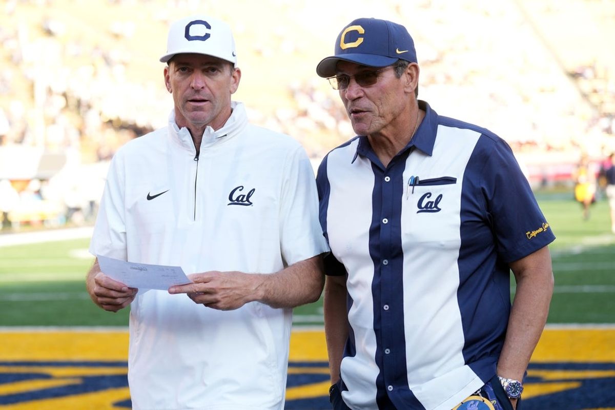 Sep 6, 2025; Berkeley, California, USA; California Golden Bears head coach Justin Wilcox (left) and general manager Ron Rivera (right) talk after defeating the Texas Southern Tigers at California Memorial Stadium. Mandatory Credit: Darren Yamashita-Imagn Images