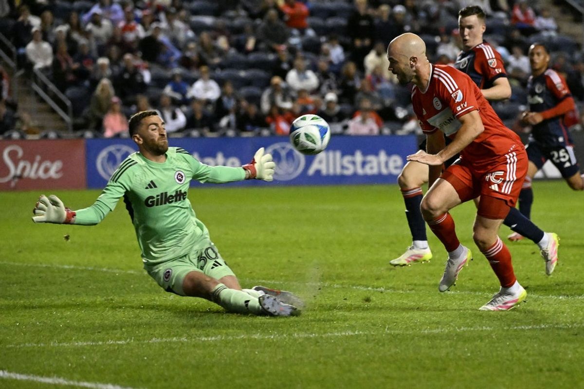 Sep 6, 2025; Bridgeview, Illinois, USA;  Chicago Fire defender Andrew Gutman (15) shoots past New England Revolution goalie Matt Turner (30) during the first half at SeatGeek Stadium. Mandatory Credit: Matt Marton-Imagn Images