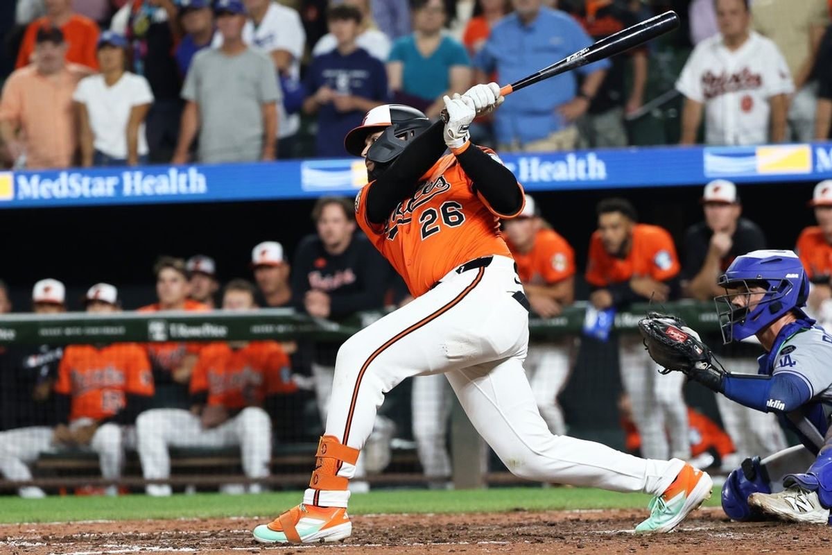 Sep 6, 2025; Baltimore, Maryland, USA; Baltimore Orioles third baseman Emmanuel Rivera (26) hits a walk off RBI single during the ninth inning against the Los Angeles Dodgers at Oriole Park at Camden Yards. Mandatory Credit: Daniel Kucin Jr.-Imagn Images