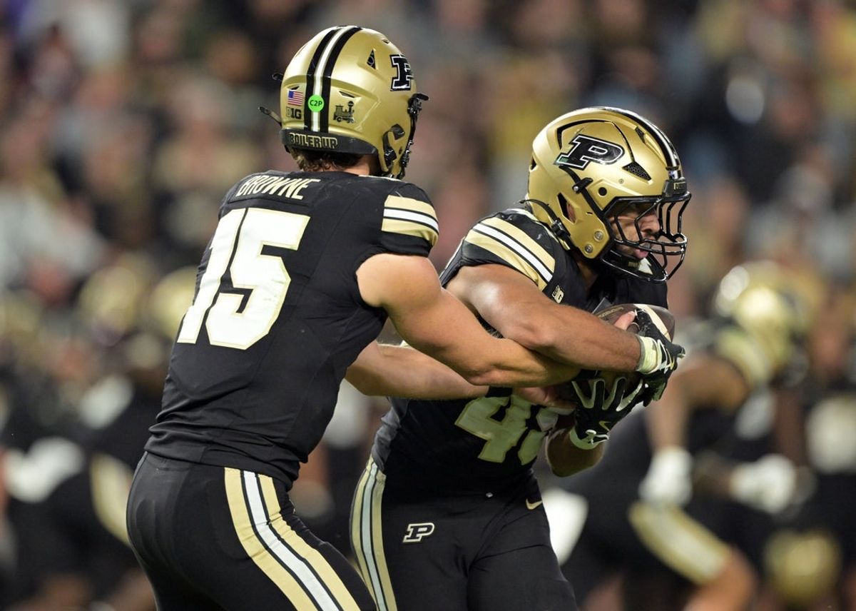 Sep 6, 2025; West Lafayette, Indiana, USA; Purdue Boilermakers quarterback Ryan Browne (15) hands off the ball to Purdue Boilermakers running back Devin Mockobee (45) during the second half against the Southern Illinois Salukis at Ross-Ade Stadium. Mandatory Credit: Marc Lebryk-Imagn Images