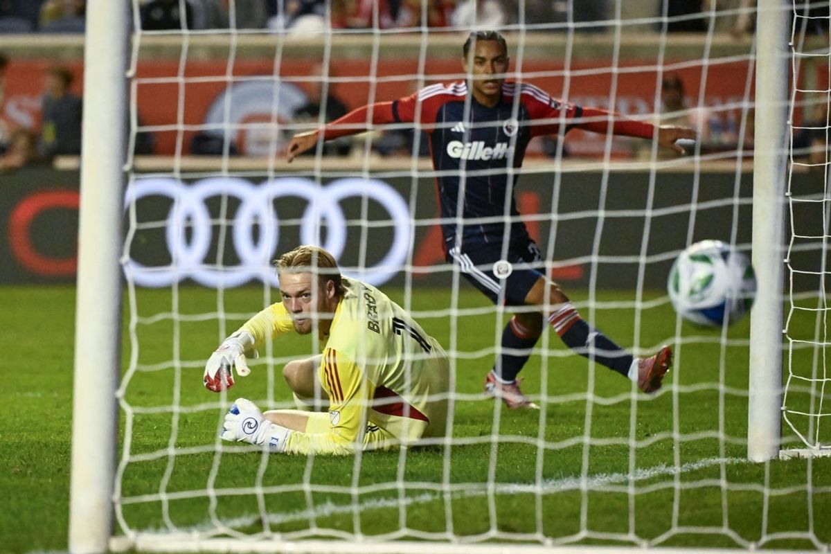 Sep 6, 2025; Bridgeview, Illinois, USA;  Chicago Fire goalkeeper Chris Brady (1) looks on after New England Revolution defender Peyton Miller (25) scores a goal during the second half at SeatGeek Stadium. Mandatory Credit: Matt Marton-Imagn Images