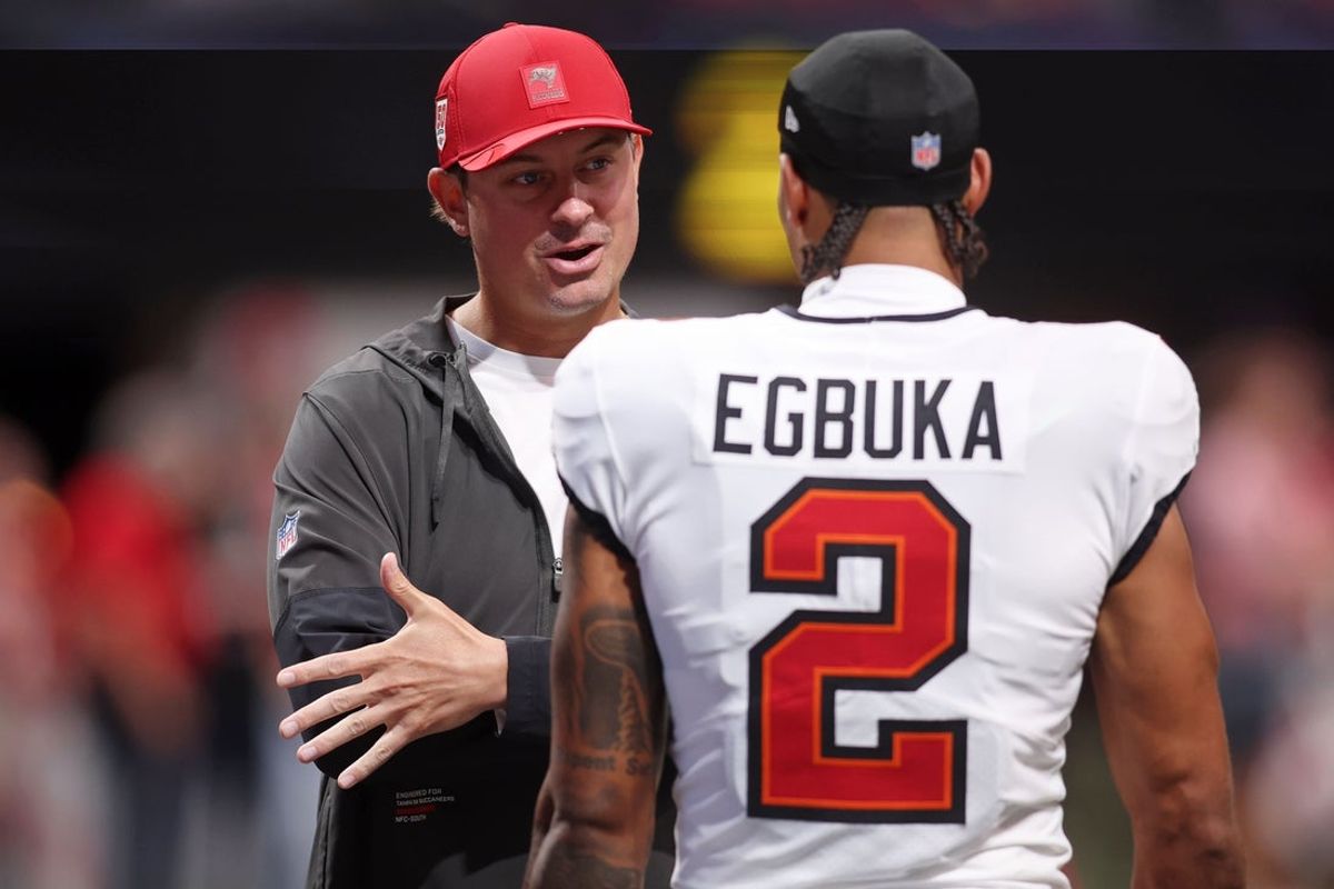 Sep 7, 2025; Atlanta, Georgia, USA; Tampa Bay Buccaneers offensive coordinator Josh Grizzard talks with wide receiver Emeka Egbuka (2) before the game against the Atlanta Falcons at Mercedes-Benz Stadium. Mandatory Credit: Brett Davis-Imagn Images