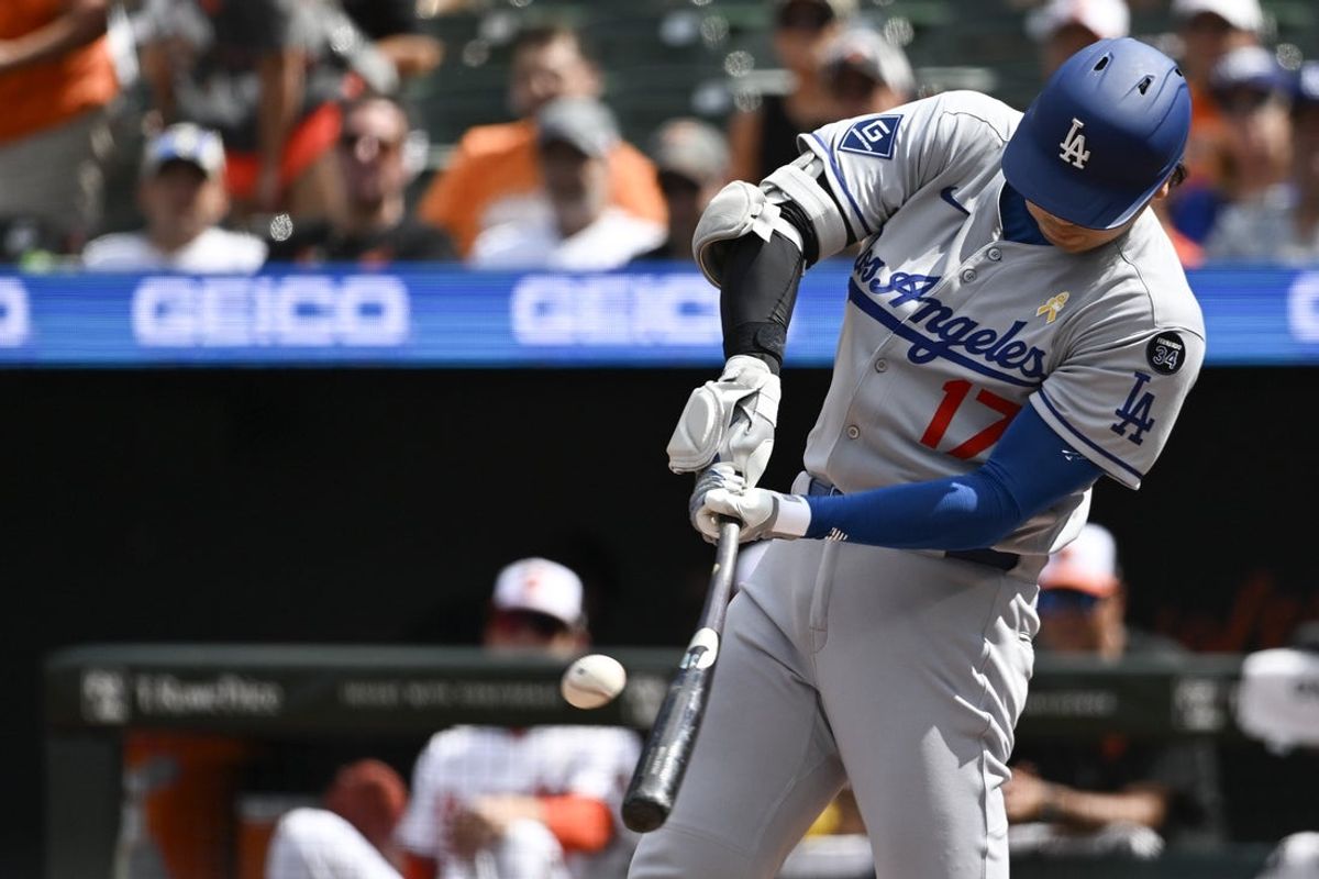 Sep 7, 2025; Baltimore, Maryland, USA;  Los Angeles Dodgers designated hitter Shohei Ohtani (17) hits a third inning solo home run against the Baltimore Orioles at Oriole Park at Camden Yards. Mandatory Credit: Tommy Gilligan-Imagn Images