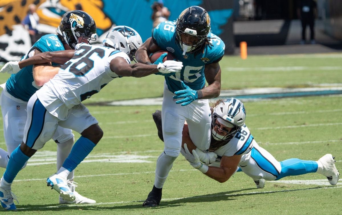 Jacksonville Jaguars running back LeQuint Allen Jr. (36) is tackled bye Carolina Panthers linebacker Christian Rozeboom (56) and Carolina Panthers cornerback Chau Smith-Wade (26) during the first quarter of an NFL football game between the Carolina Panthers at Jacksonville Jaguars at EverBank Stadium Sunday September 7, 2025. [Doug Engle/Florida Times-Union]